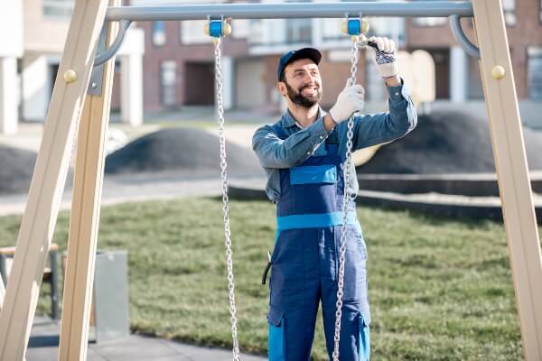 A professional puts together a playground structure.