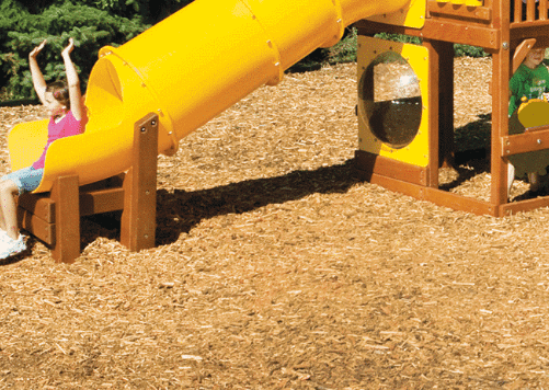 Child coming out the end of a Rainbow Play System slide