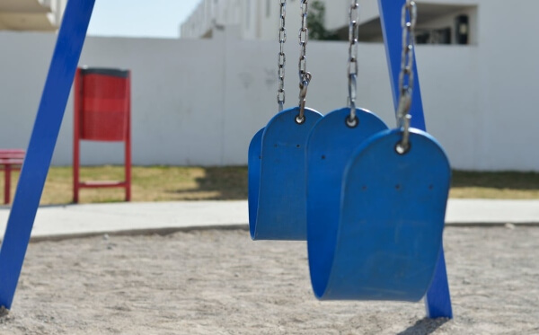 A swing set that was safely built stands ready for kids to enjoy it.